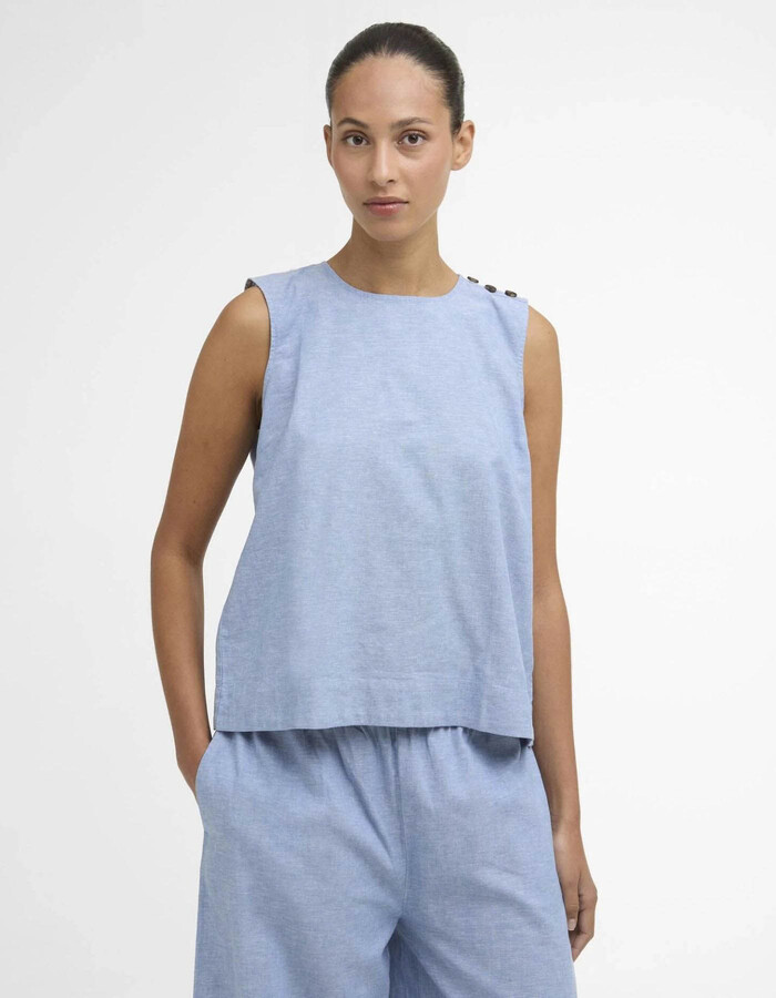 Blauwe mouwloze bloes met knoopdetails